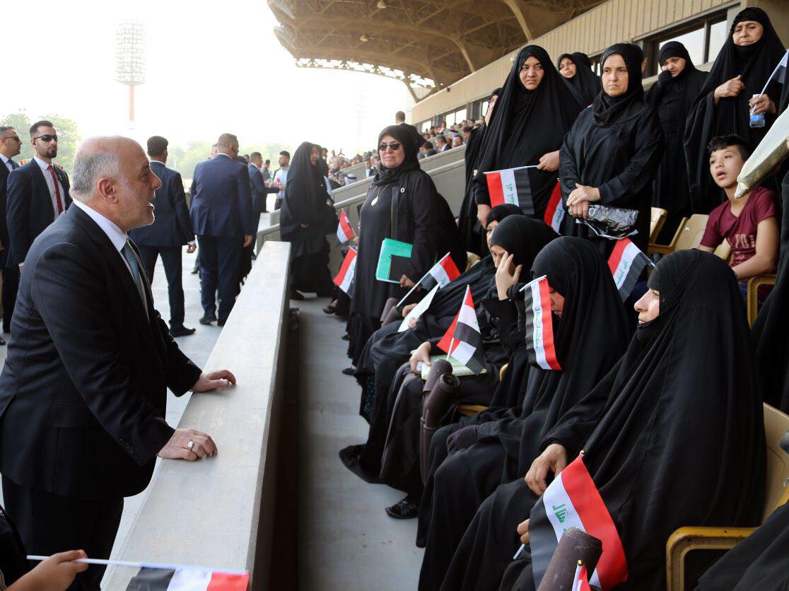 Iraqi Prime Minister Haider al-Abadi with the families of the fallen Iraqi soldiers during the military parade in Baghdad, July 15, 2017. (Photo: Iraqi Prime Minister’s Press Office)